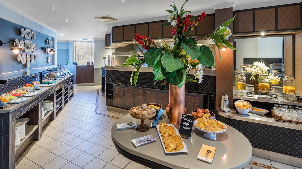 Restaurant with pastries and flowers at the entrance