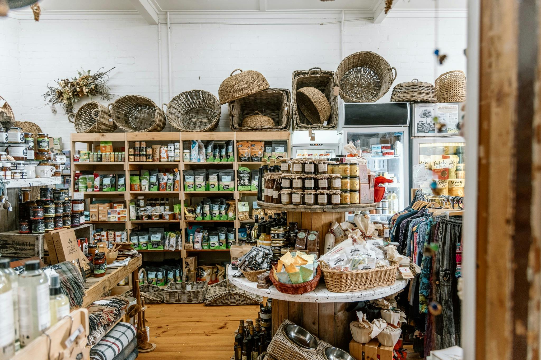 Shelf full of organic groceries and local preserves.