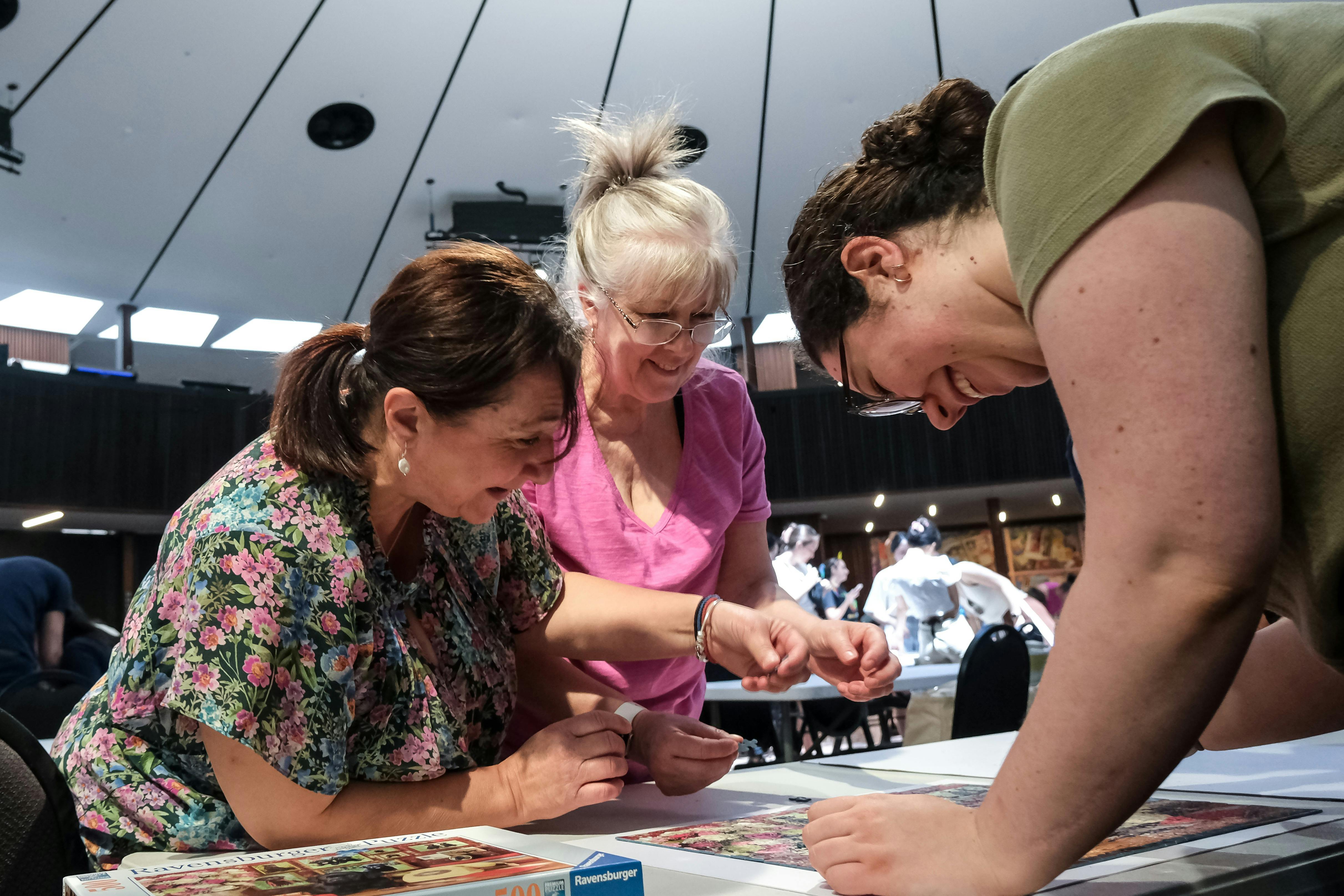 Three women puzzling together