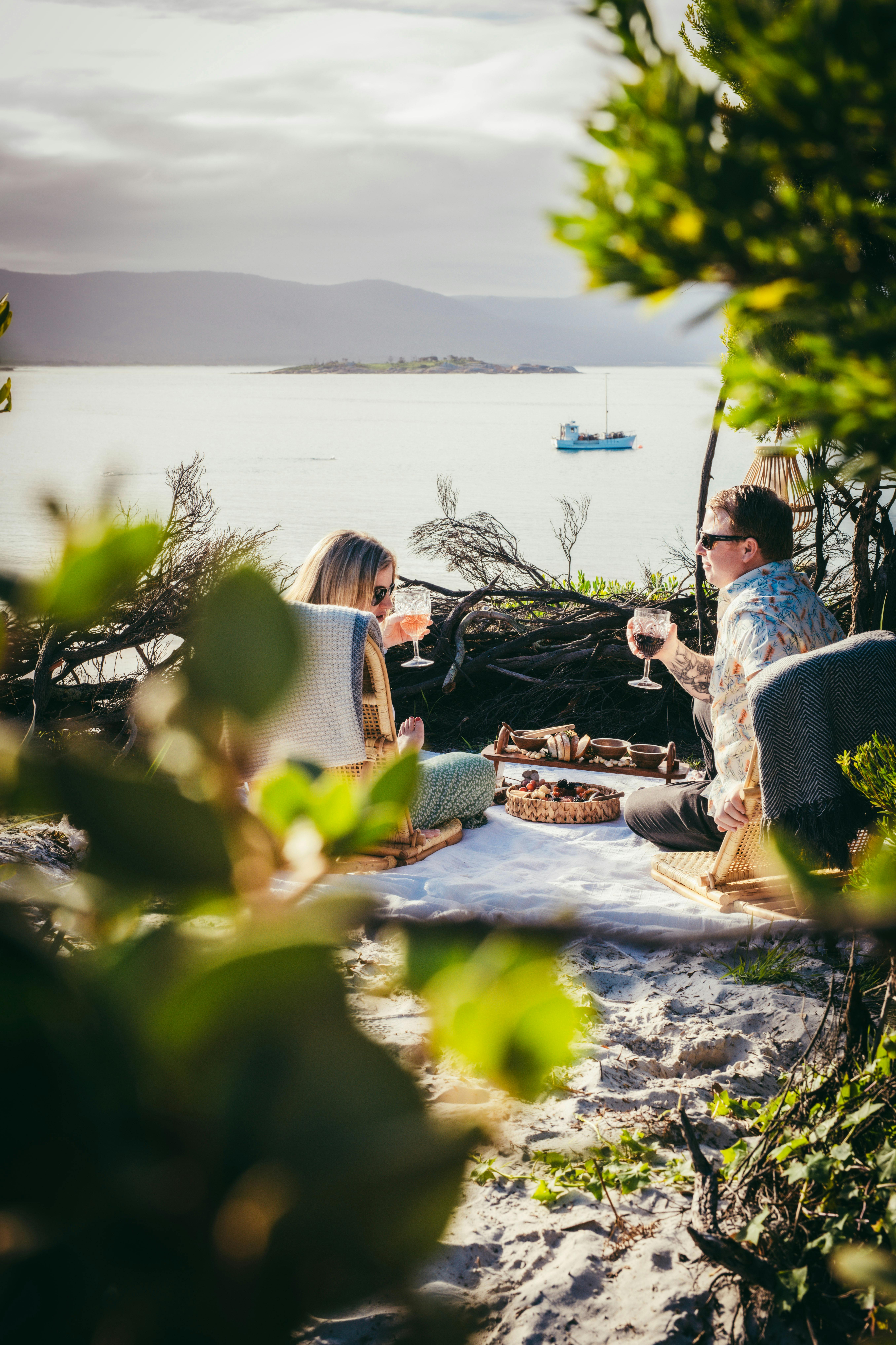 Beach picnic with wicker chair and gourmet platter