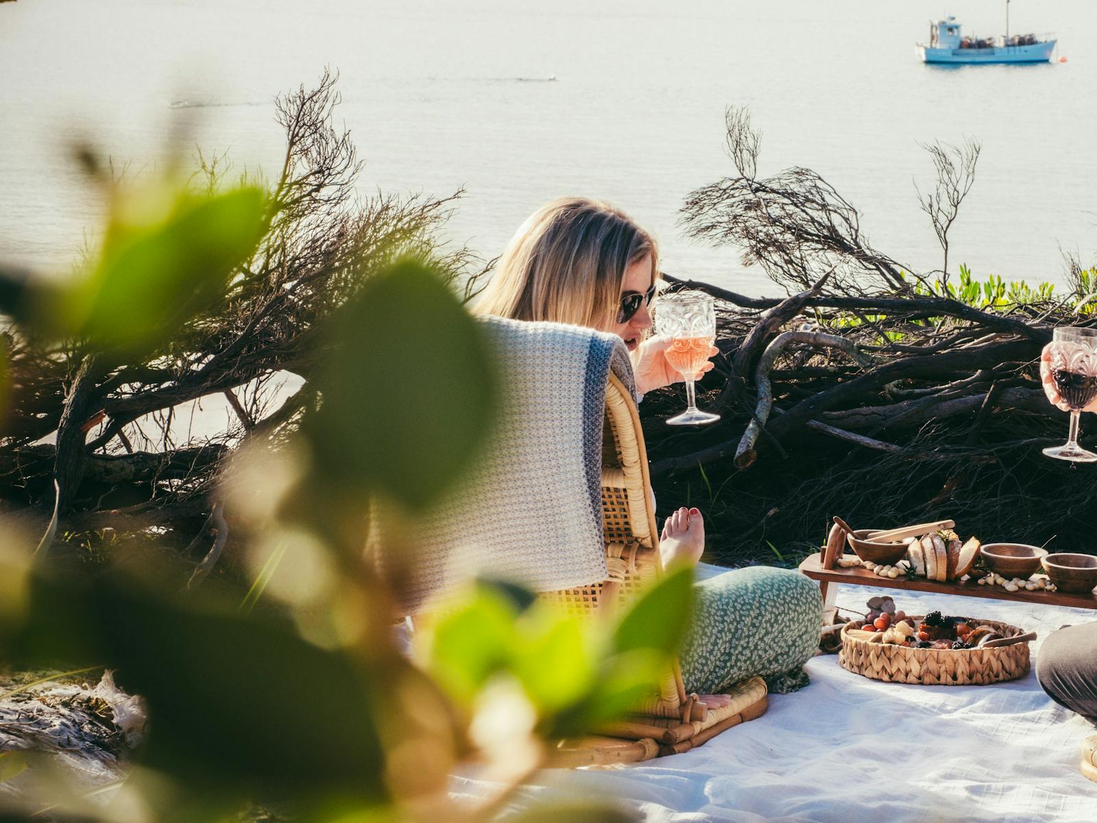Beach picnic with wicker chair and gourmet platter