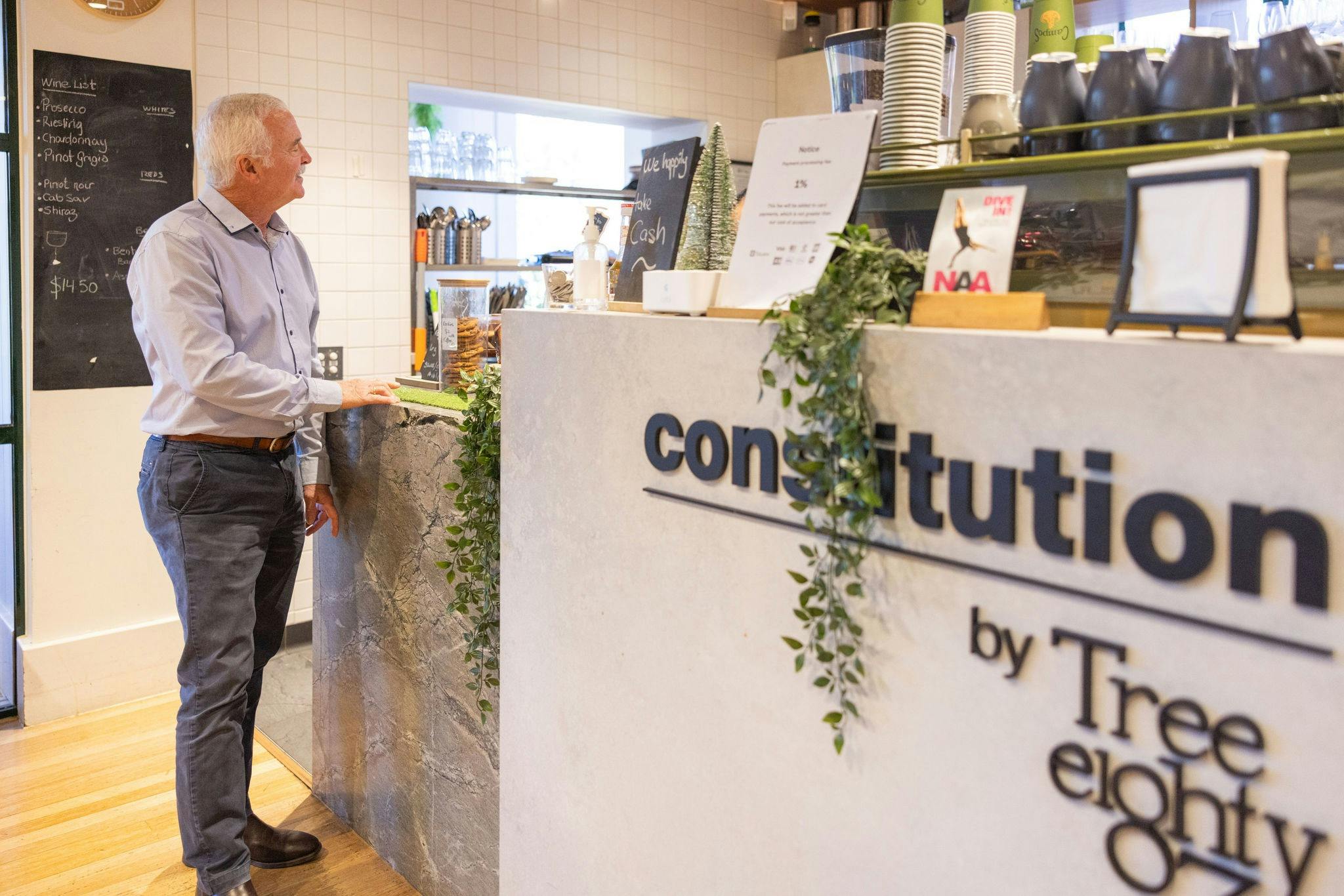 Gentleman ordering coffee at cafe counter