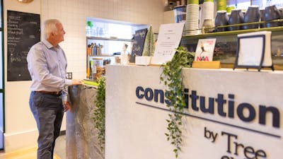 Gentleman ordering coffee at cafe counter