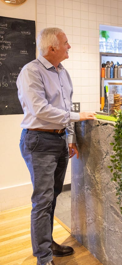 Gentleman ordering coffee at cafe counter