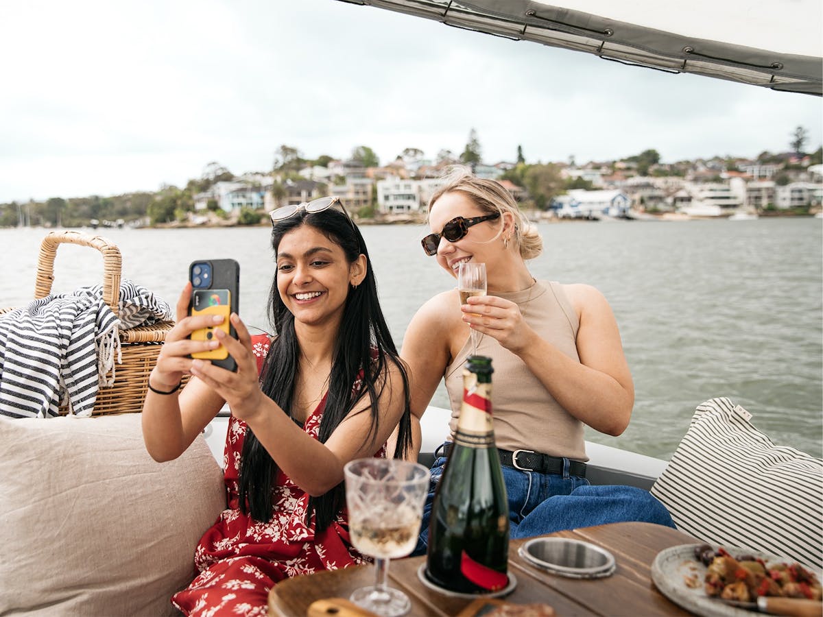 Two women take a selfie onboard a GoBoat