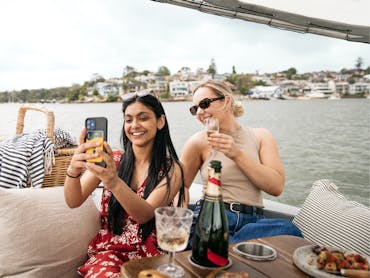 Two women take a selfie onboard a GoBoat
