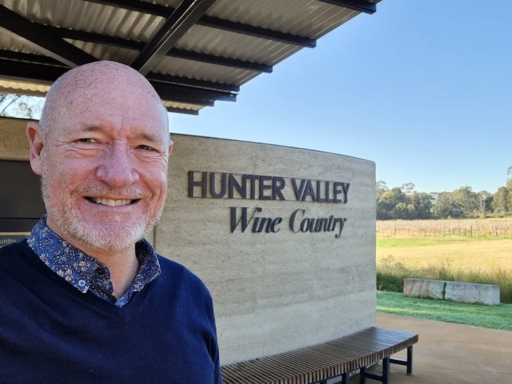 Tour Guide in front of Hunter Valley Wine Country Wall
