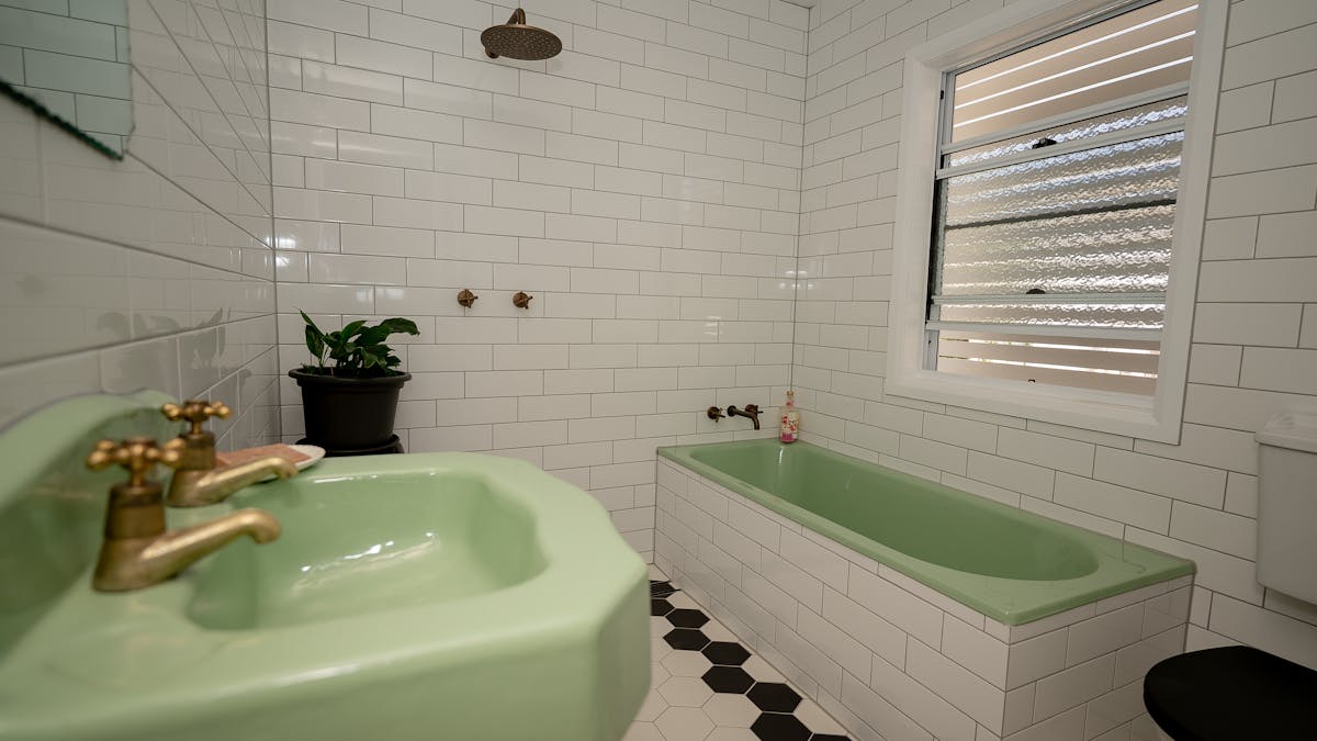 Contemporary bathroom featuring original cast iron bathtub and hand basin