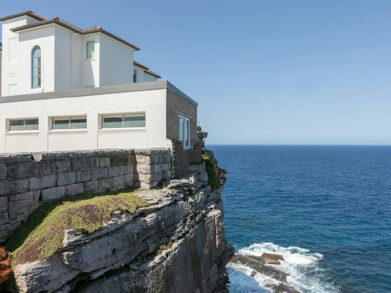 Cliffside apartment with breathtaking views of the ocean and rocky coastline.