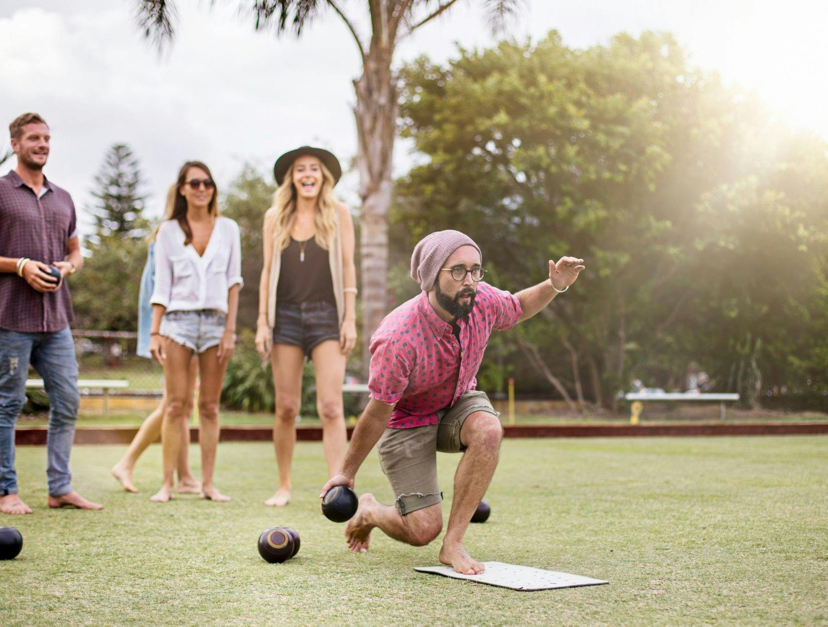 Friends playing lawn bowls