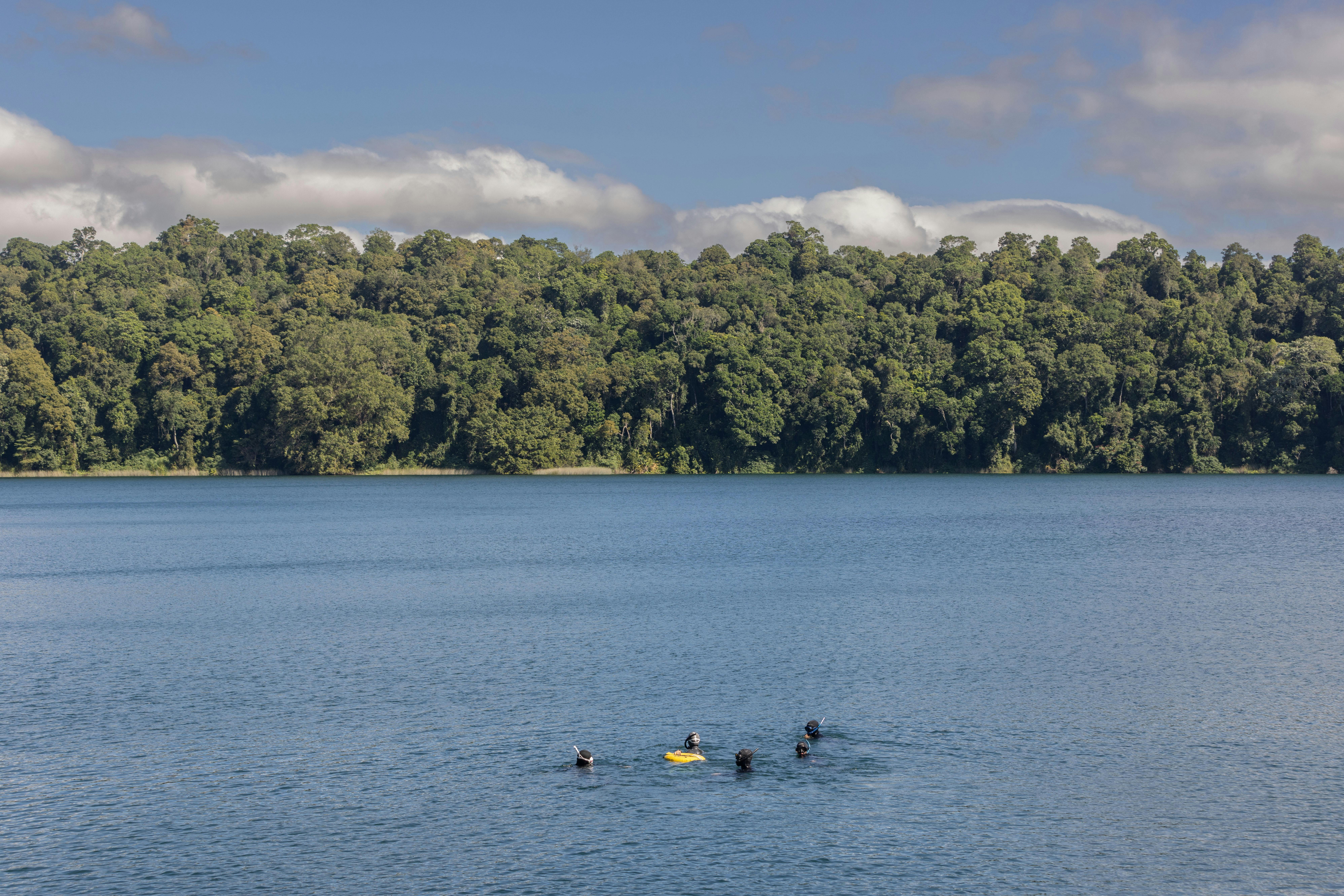 The beautiful calm waters of Lake Eacham - Group of students are practicing depth training