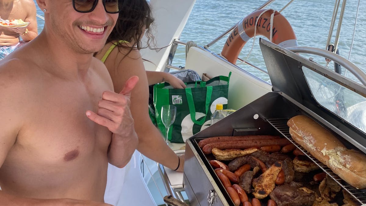 Passengers cooking a BYO BBQ on a private boat charter