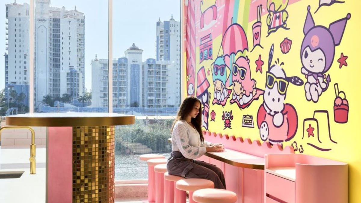 Customers at a pink service counter with Sanrio characters in the background.