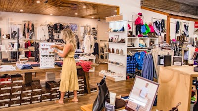 A woman looking at Le Specs sunglasses