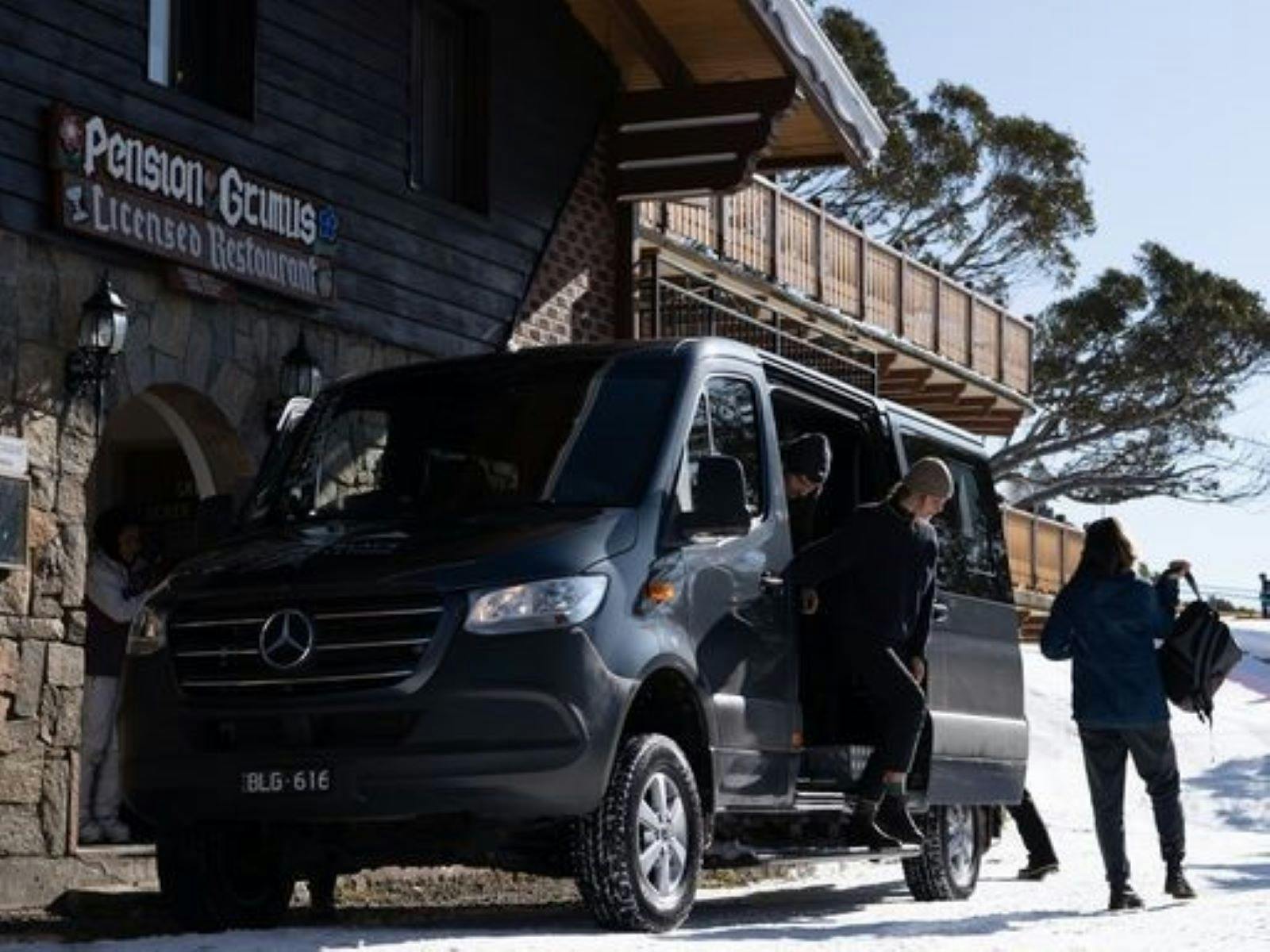 Double Black Alpine passenger van delivering guests to their accommodation in the snow.