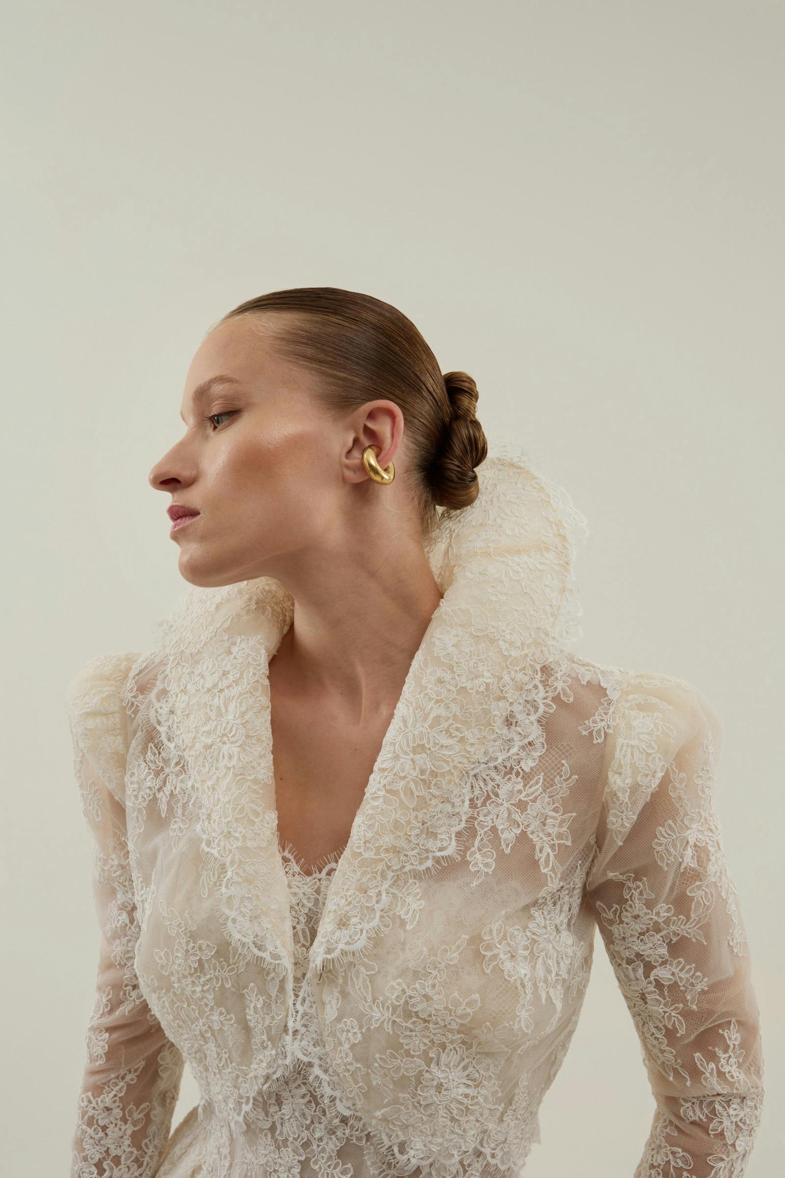 lace ball gown features a sculpted illusion corset adorned with intricate floral lace