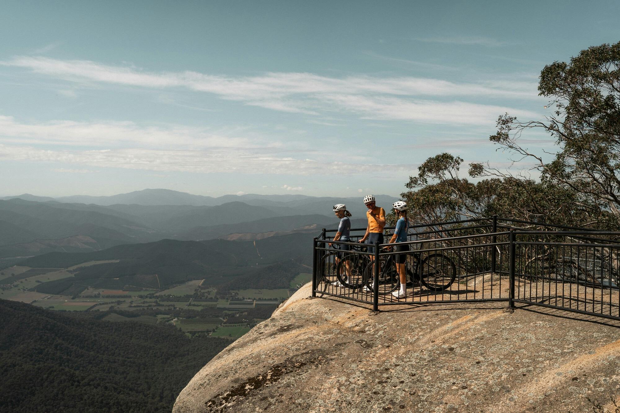 Three cyclists at the top of the Mt Buffalo 7 Peaks Challenge route