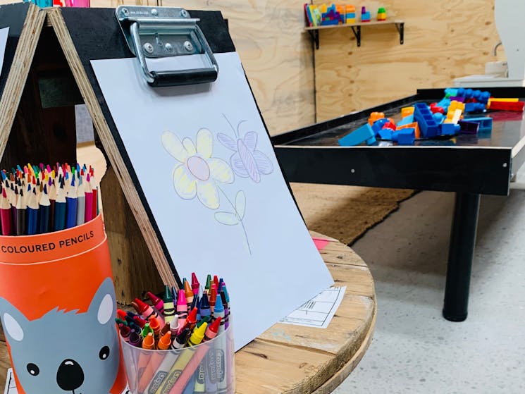 Kids play area at The Roastery showing a colouring station and block building table