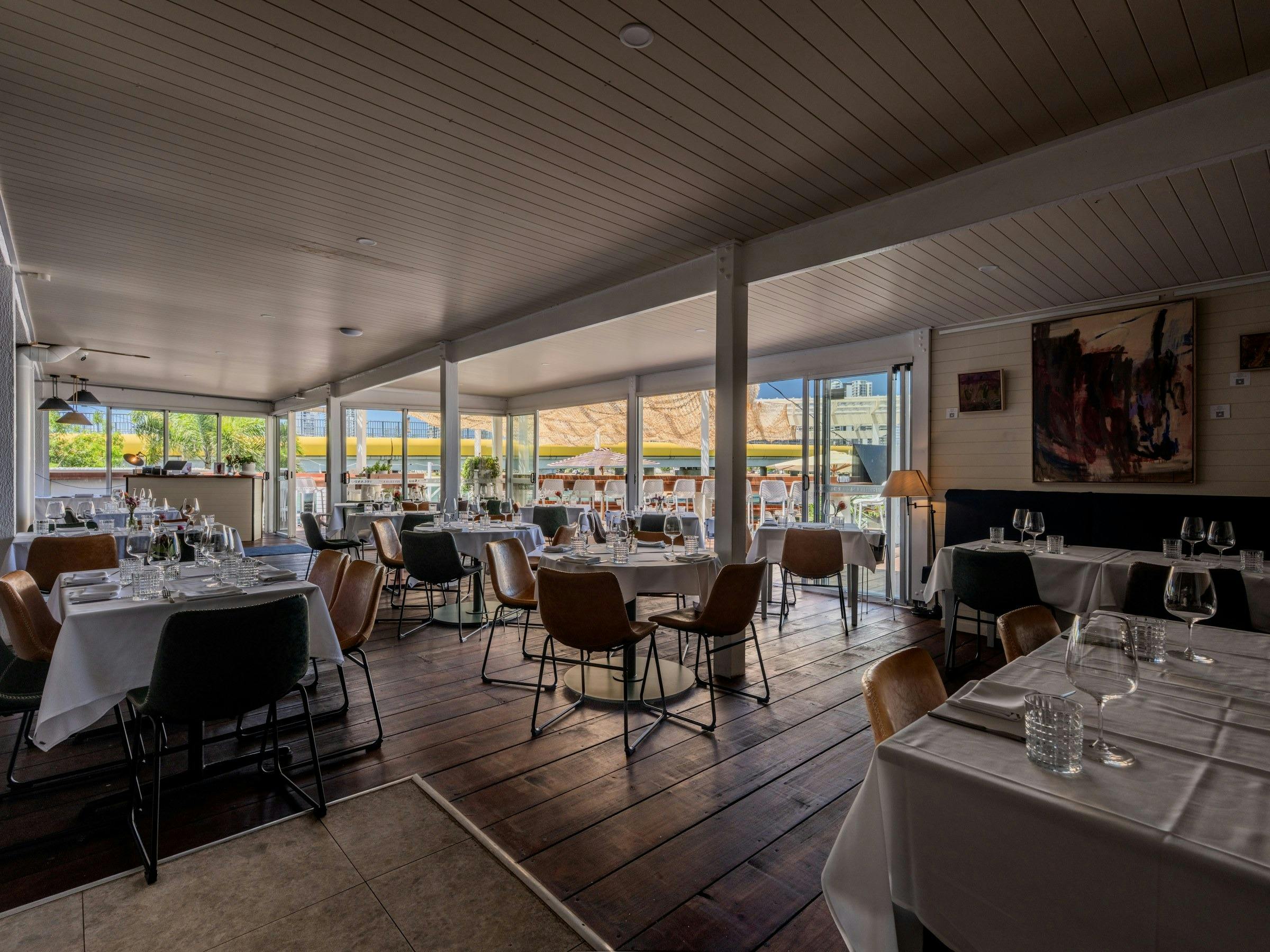 River House dining room set for dinner with original artwork on the walls