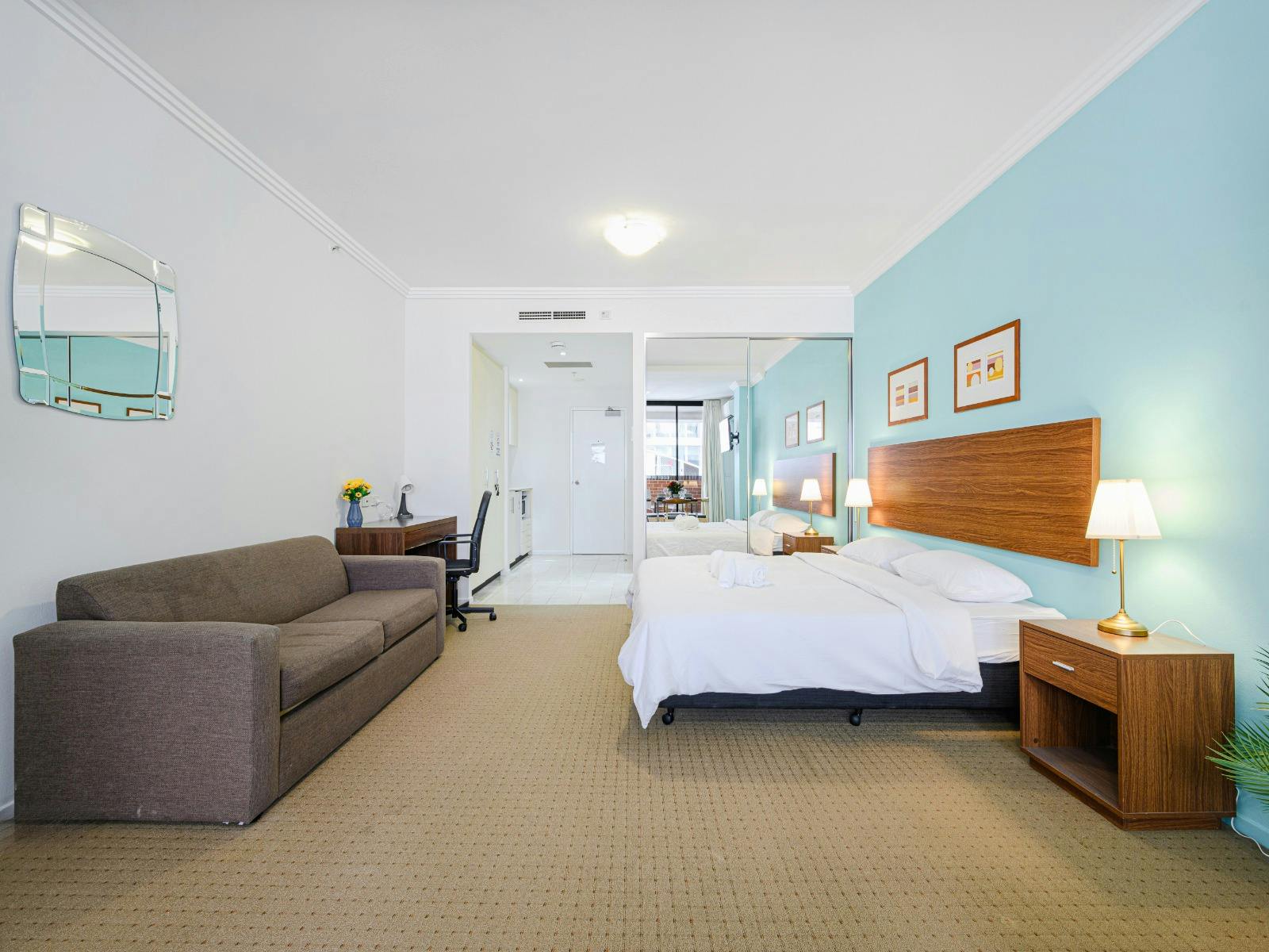 Open-plan perspective featuring sofa seating, the king-size bed near the entrance.