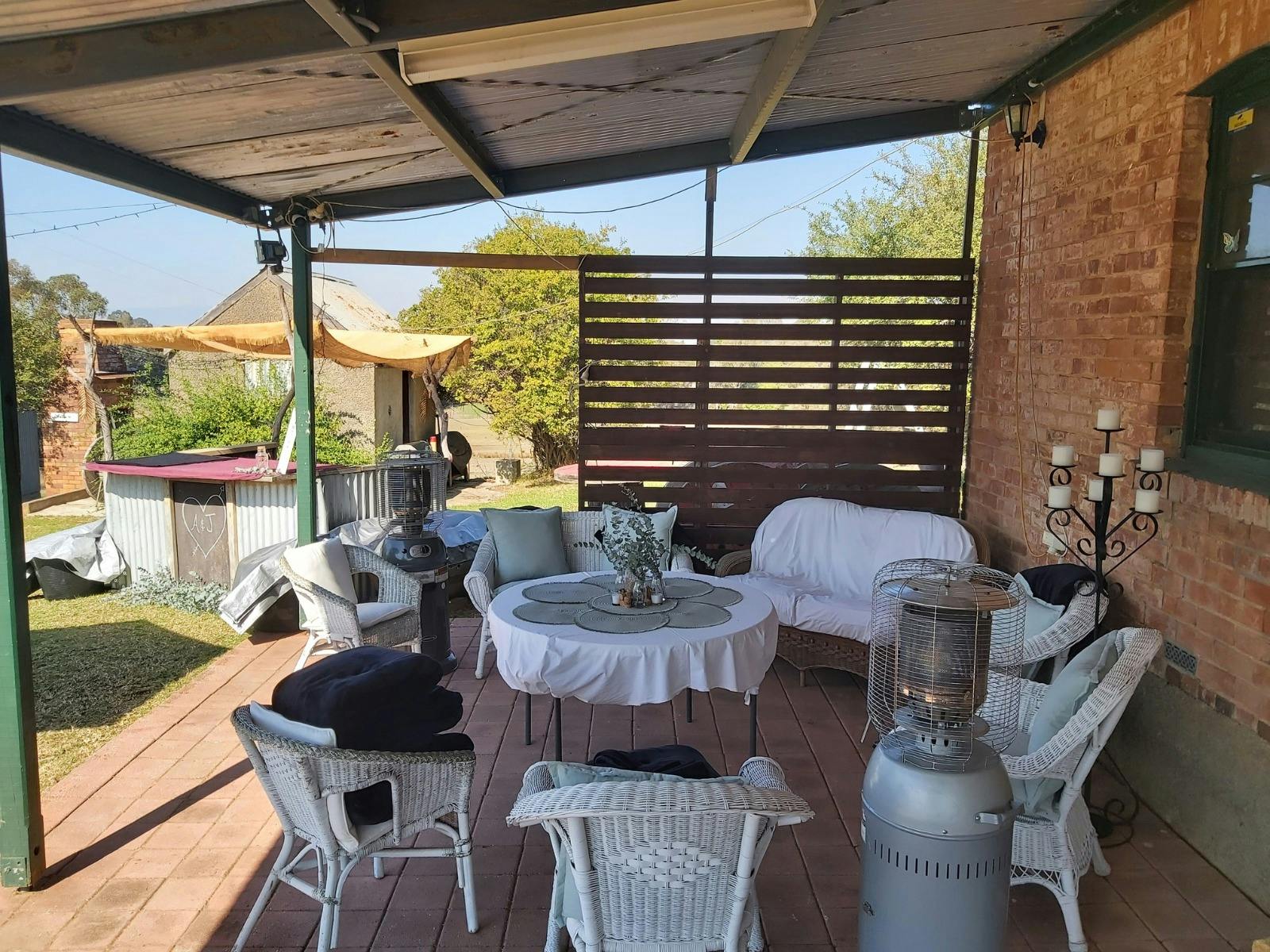 The cellar door verandah set for a wedding with white seating at Splitters Creek Vineyard