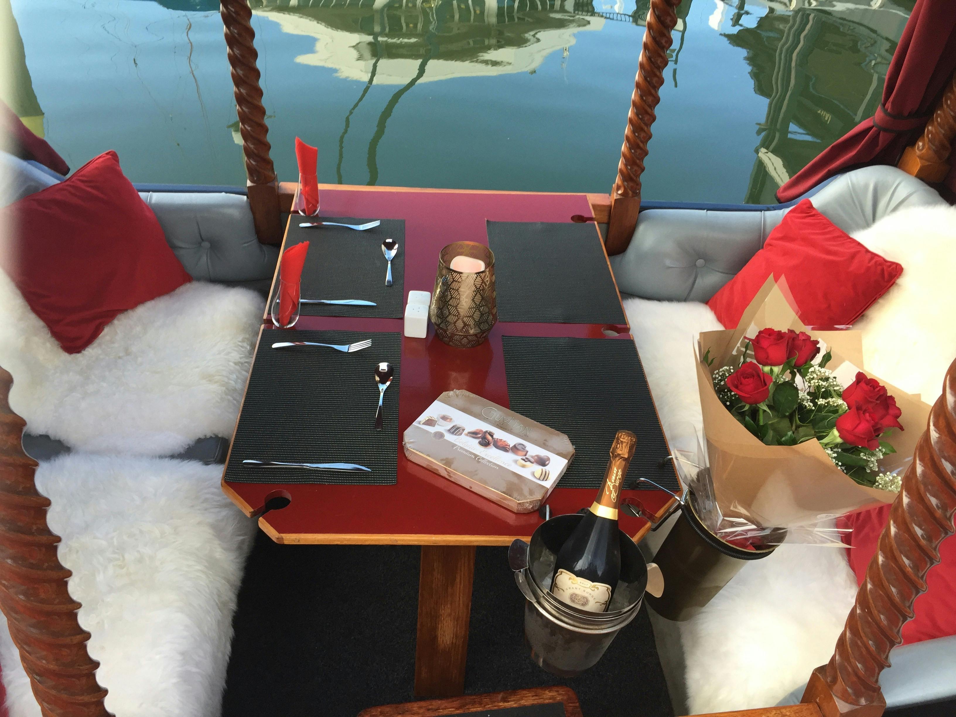 Bouquet of red roses, chocolates and sparkling wine