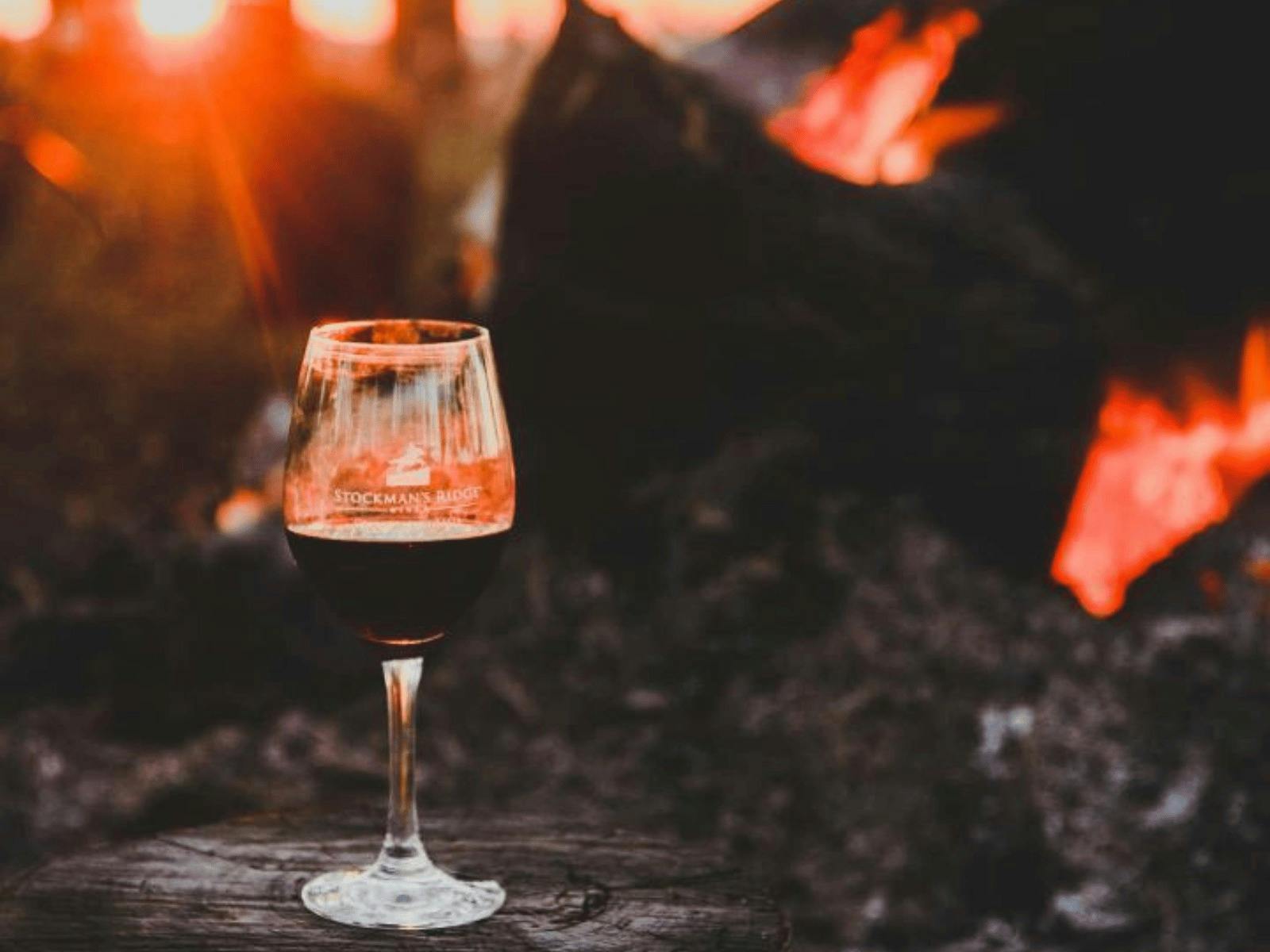 artistic photo of wine glass in front of outdoor fire at Stockmans Ridge Wines