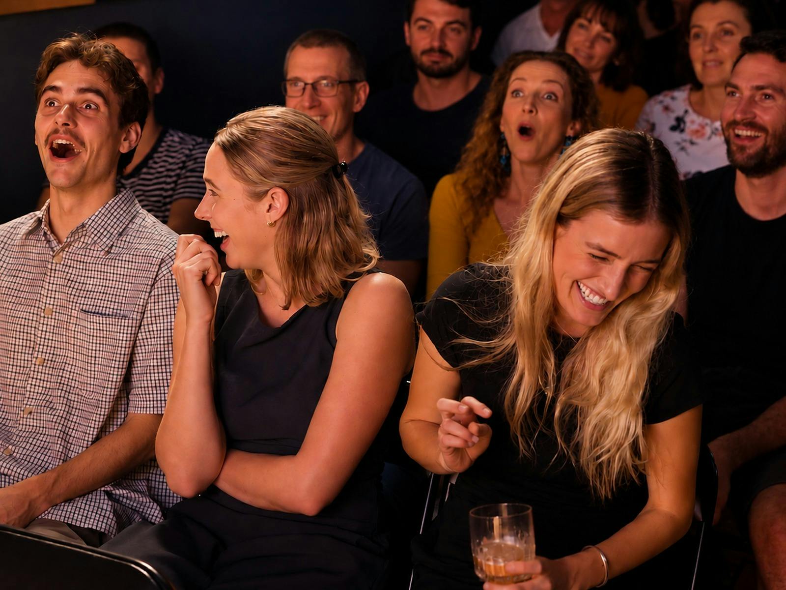 Audience members laughing at a comedy show in Glebe, Sydney
