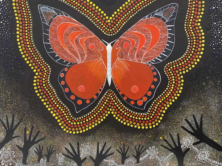 Aboriginal painting of butterfly and reaching hands