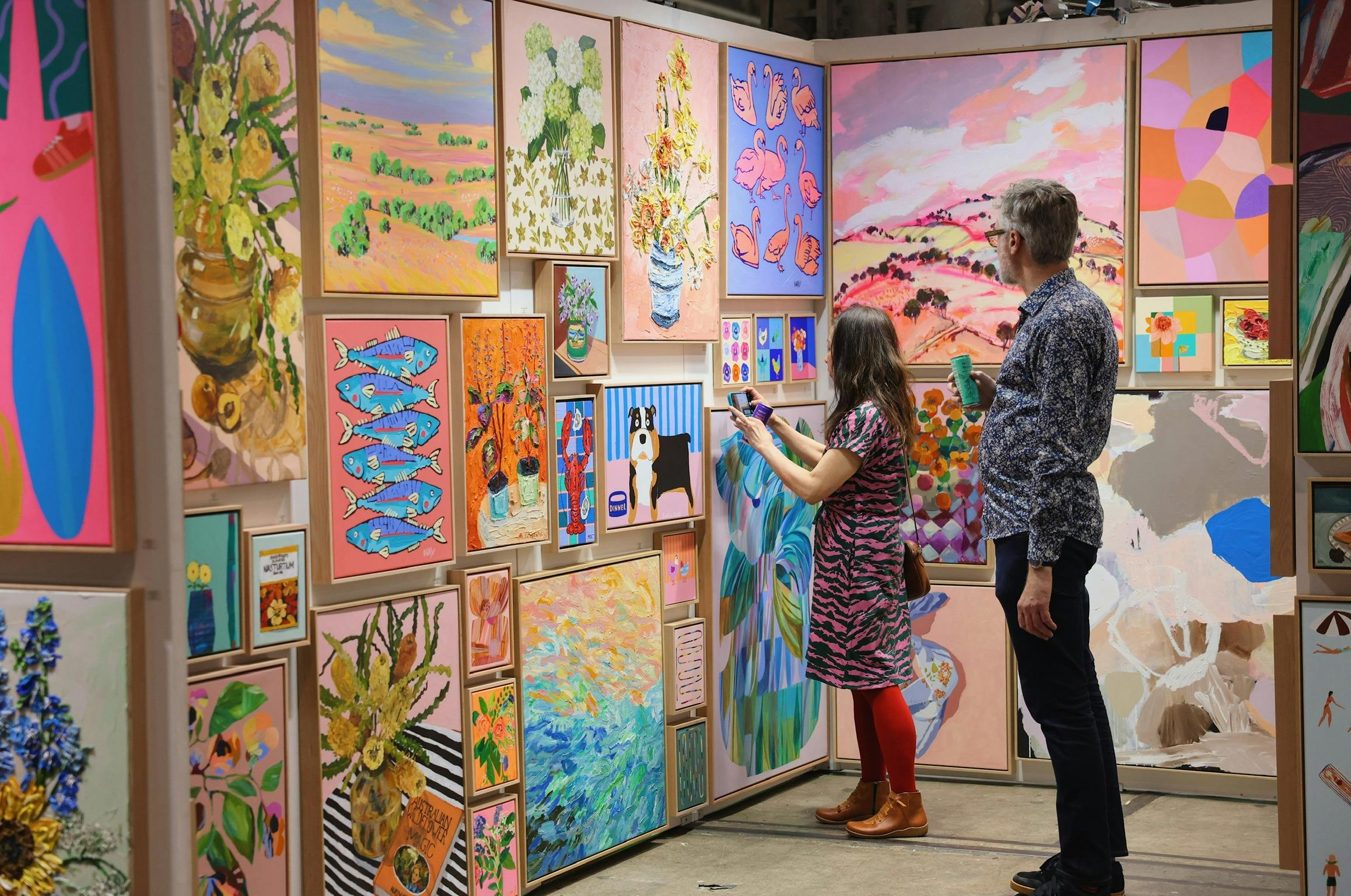Attendees viewing paintings