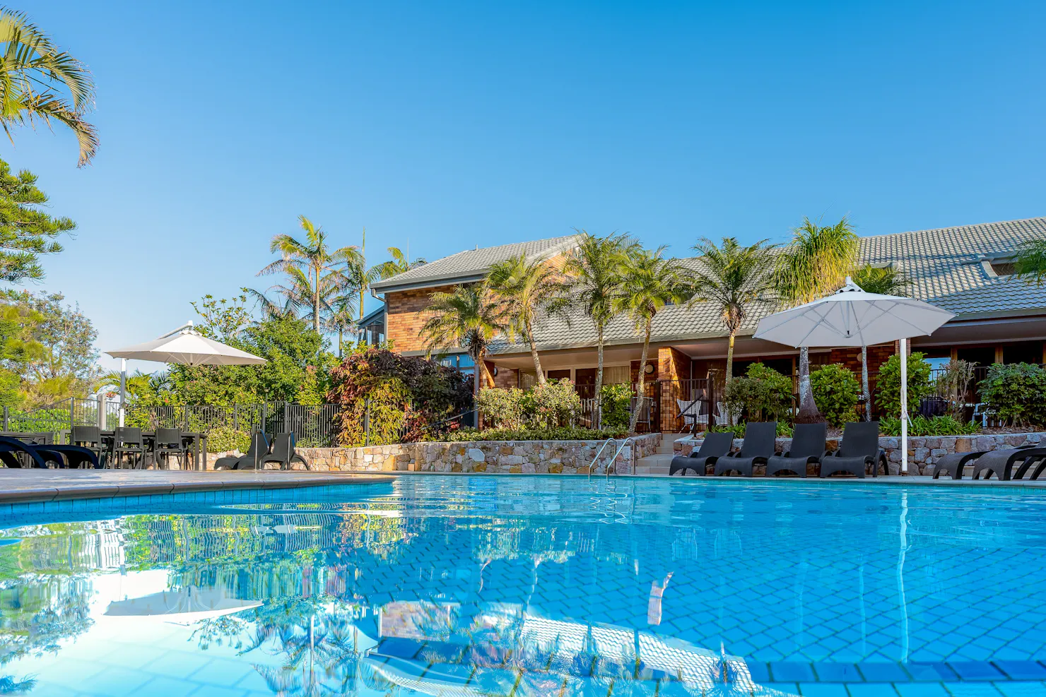 Beautiful blue image of the resort swimming pool at Glen Eden Beach Resort