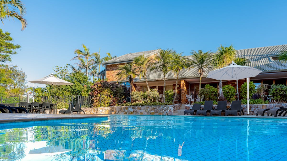 Beautiful blue image of the resort swimming pool at Glen Eden Beach Resort