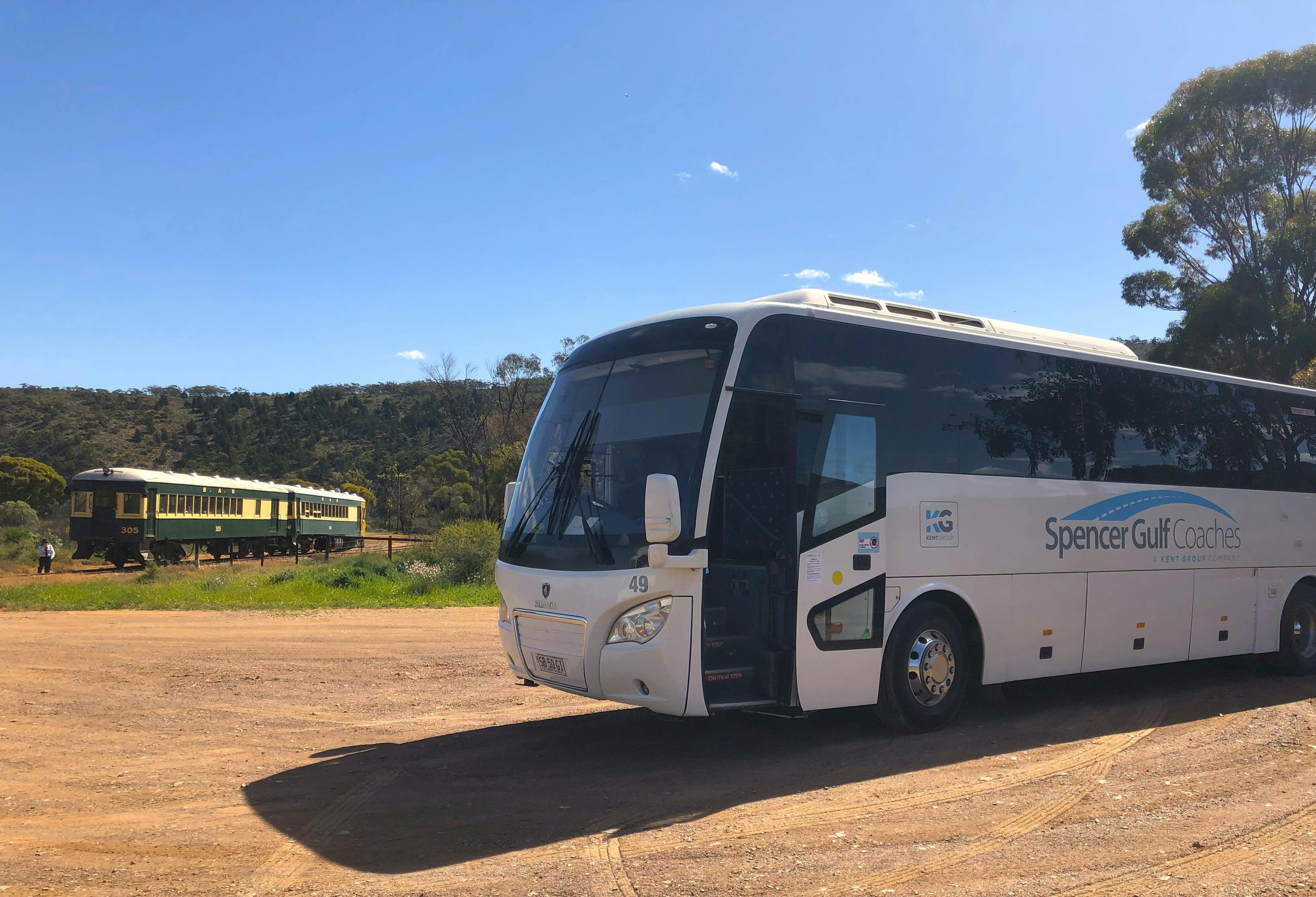 Full sized coach with train in background