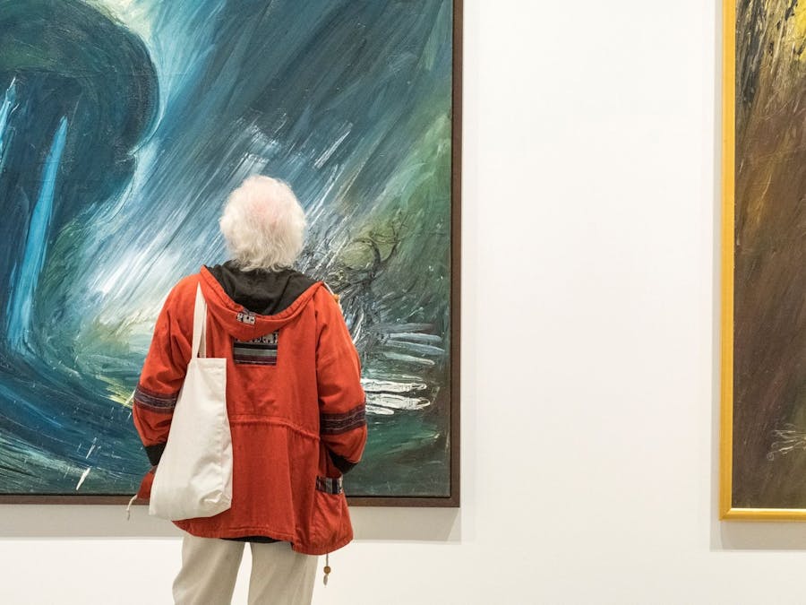 Visitor looking at landscape paintings by Arthur Boyd