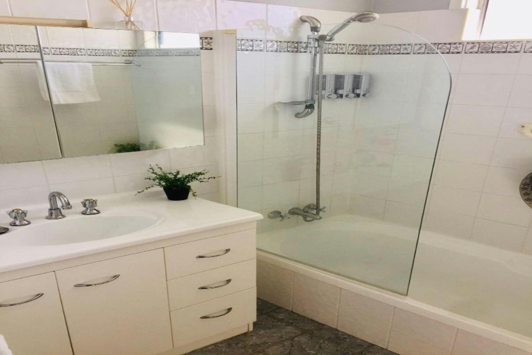 The main bathroom has a bath, shower and toilet