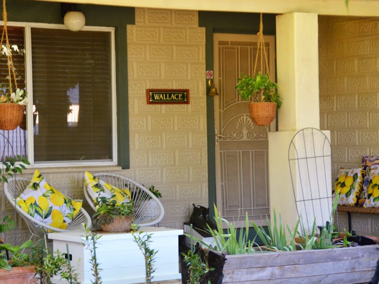 Porch area, seats, front door, window, plants
