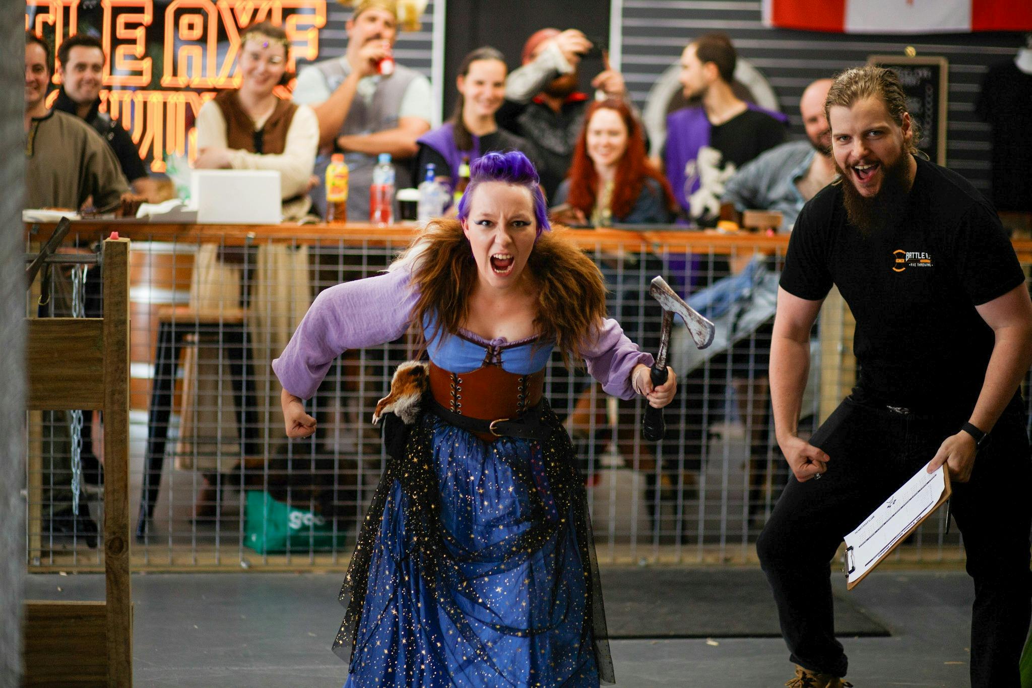 First time axe thrower celebrating a successful throw at Battle Axe Throwing