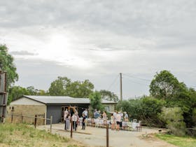 Our cellar door in the distance with people mingling in front enjoying a glass of wine
