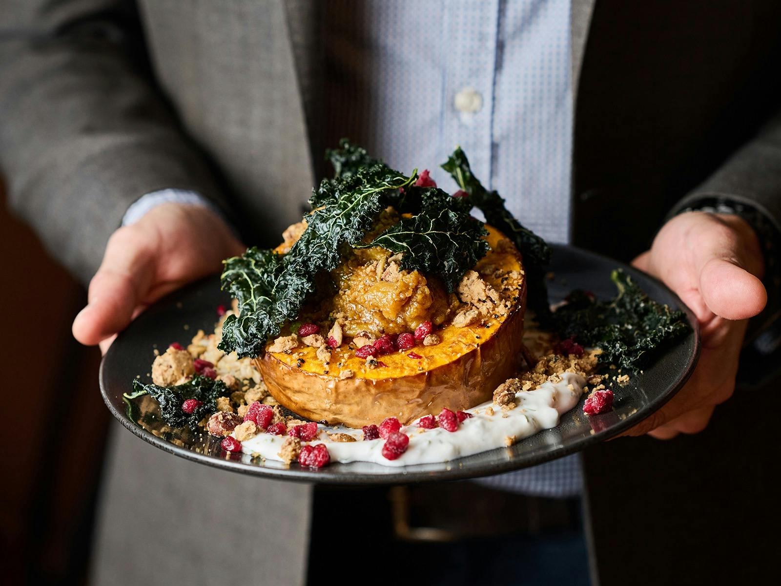 Person holding a main meal close up