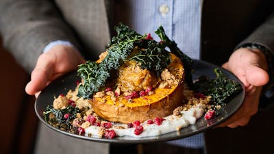 Person holding a main meal close up