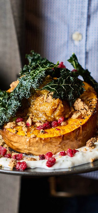 Person holding a main meal close up