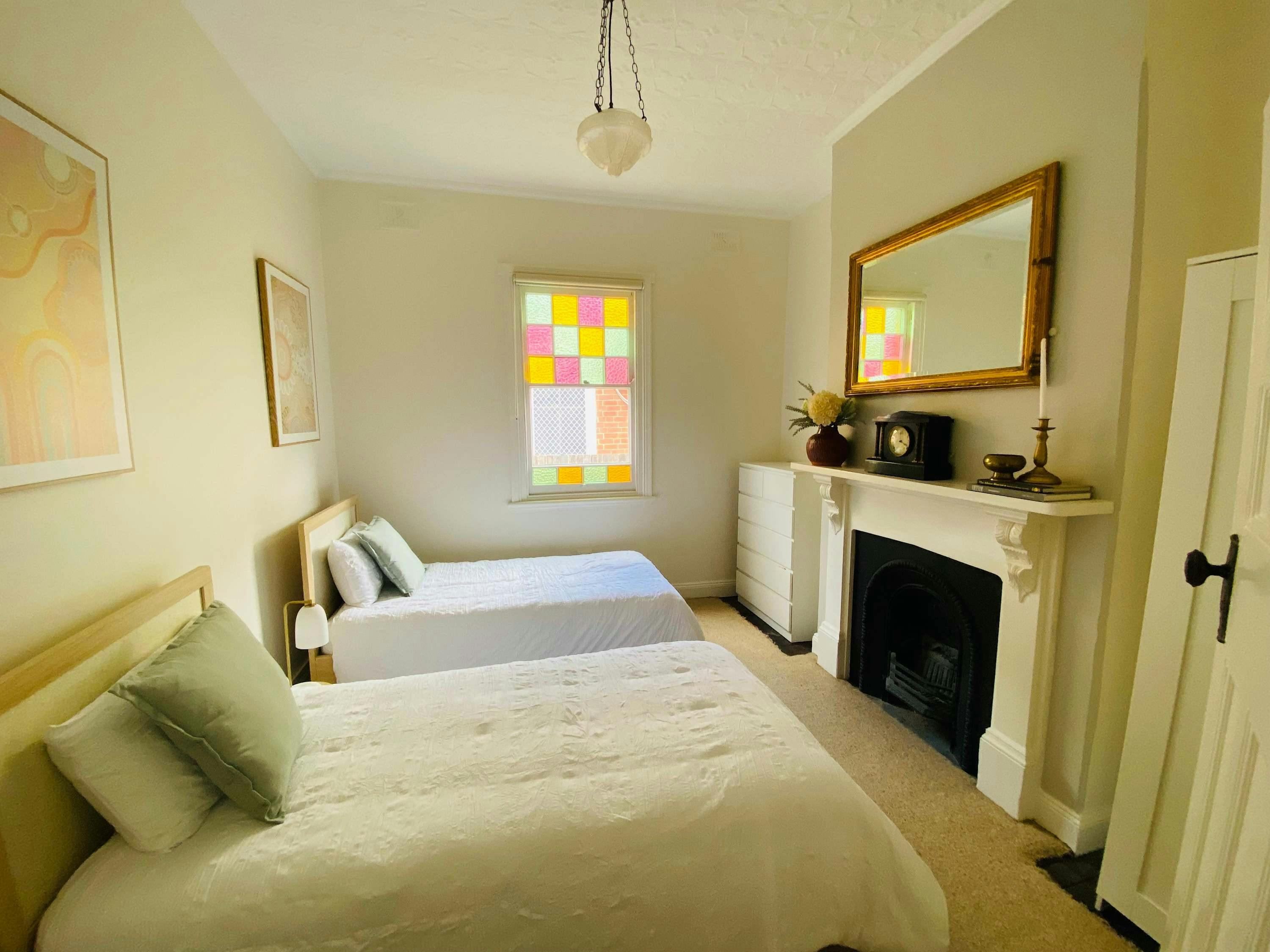 Drawers with 2 single beds, carpet, and decor