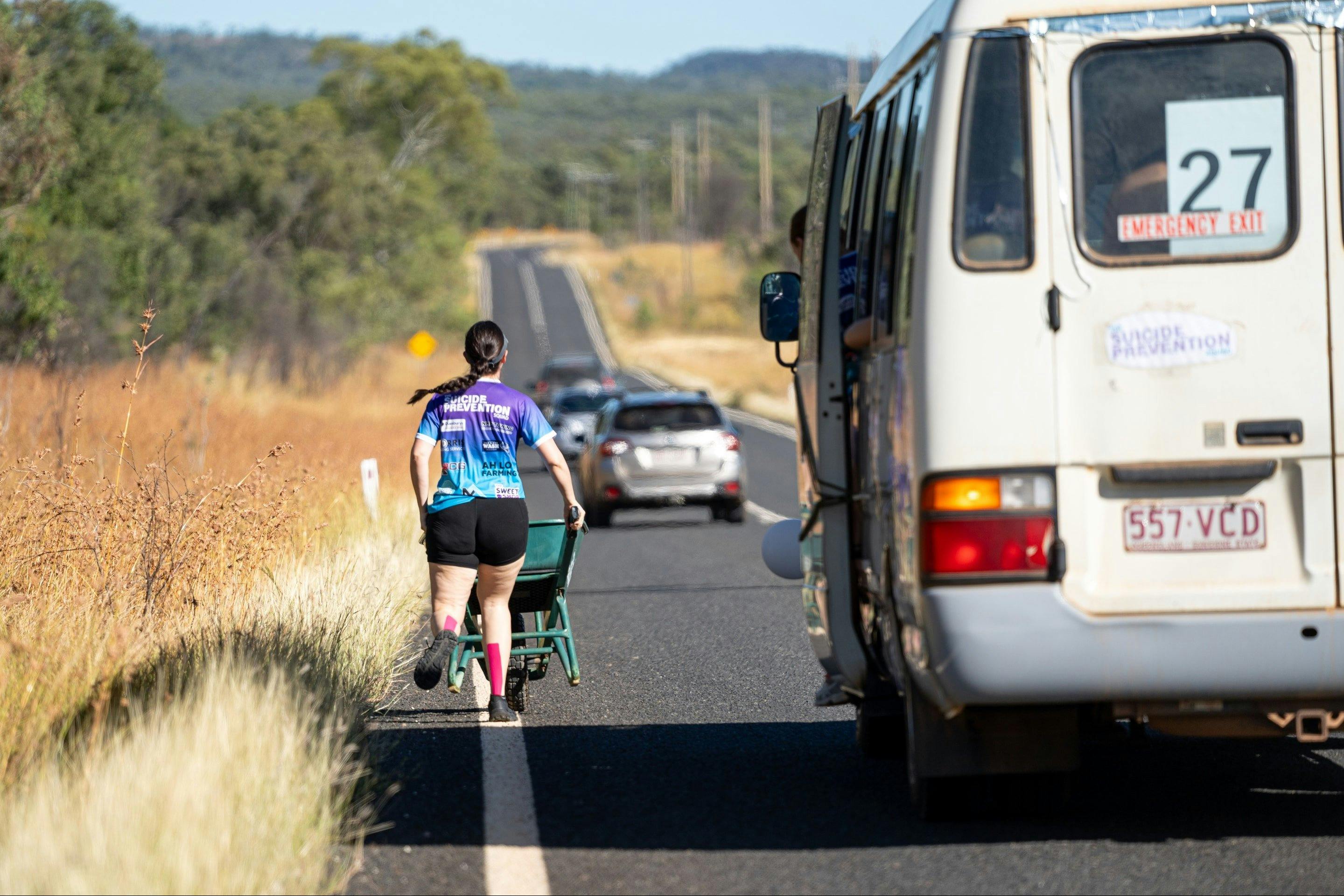 A woman runs with a wheelbarrow in The Great Wheelbarrow Race, Mareeba, FNQ.