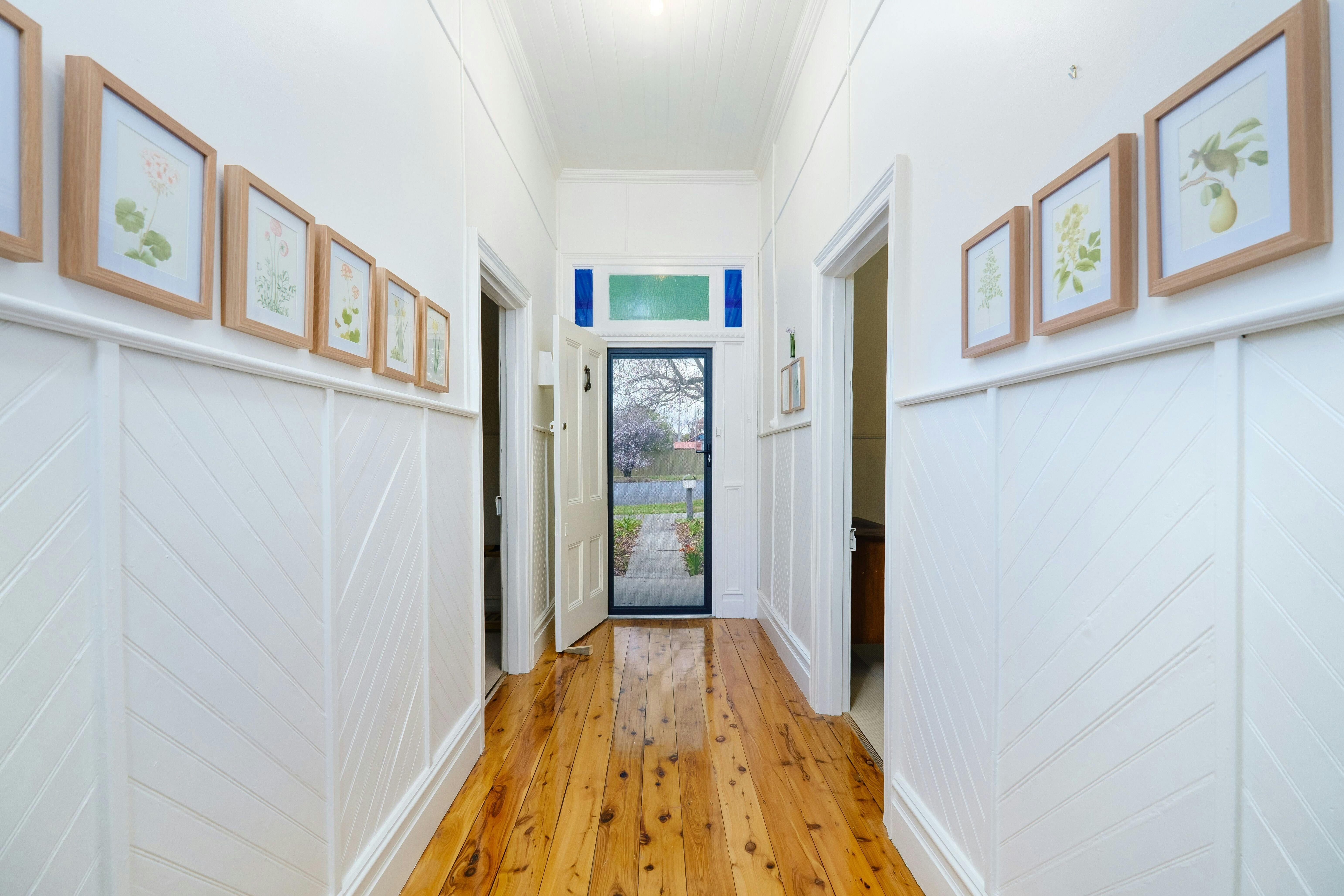 Entrance hallway featuring beautiful botanical prints by our grandmother who was an acclaimed artist
