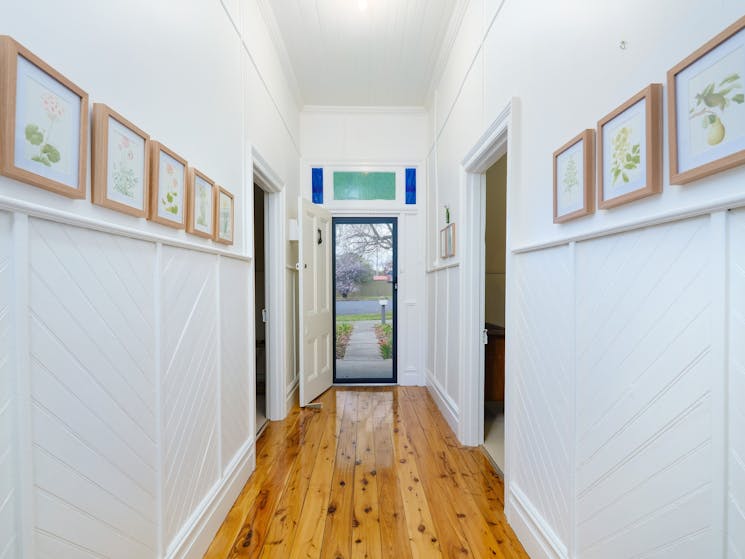 Entrance hallway featuring beautiful botanical prints by our grandmother who was an acclaimed artist