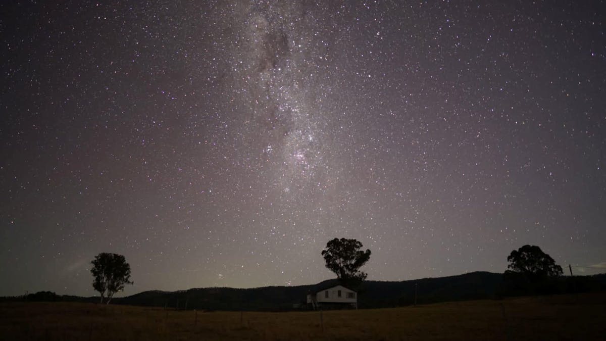 stargazing- miklyway with cottage in photo