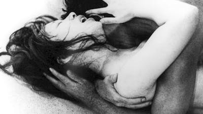 Black and white image of two figures embracing