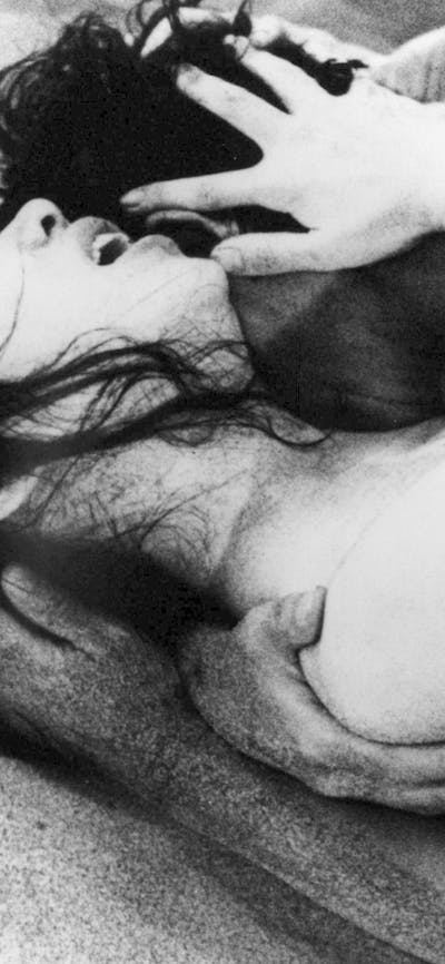 Black and white image of two figures embracing