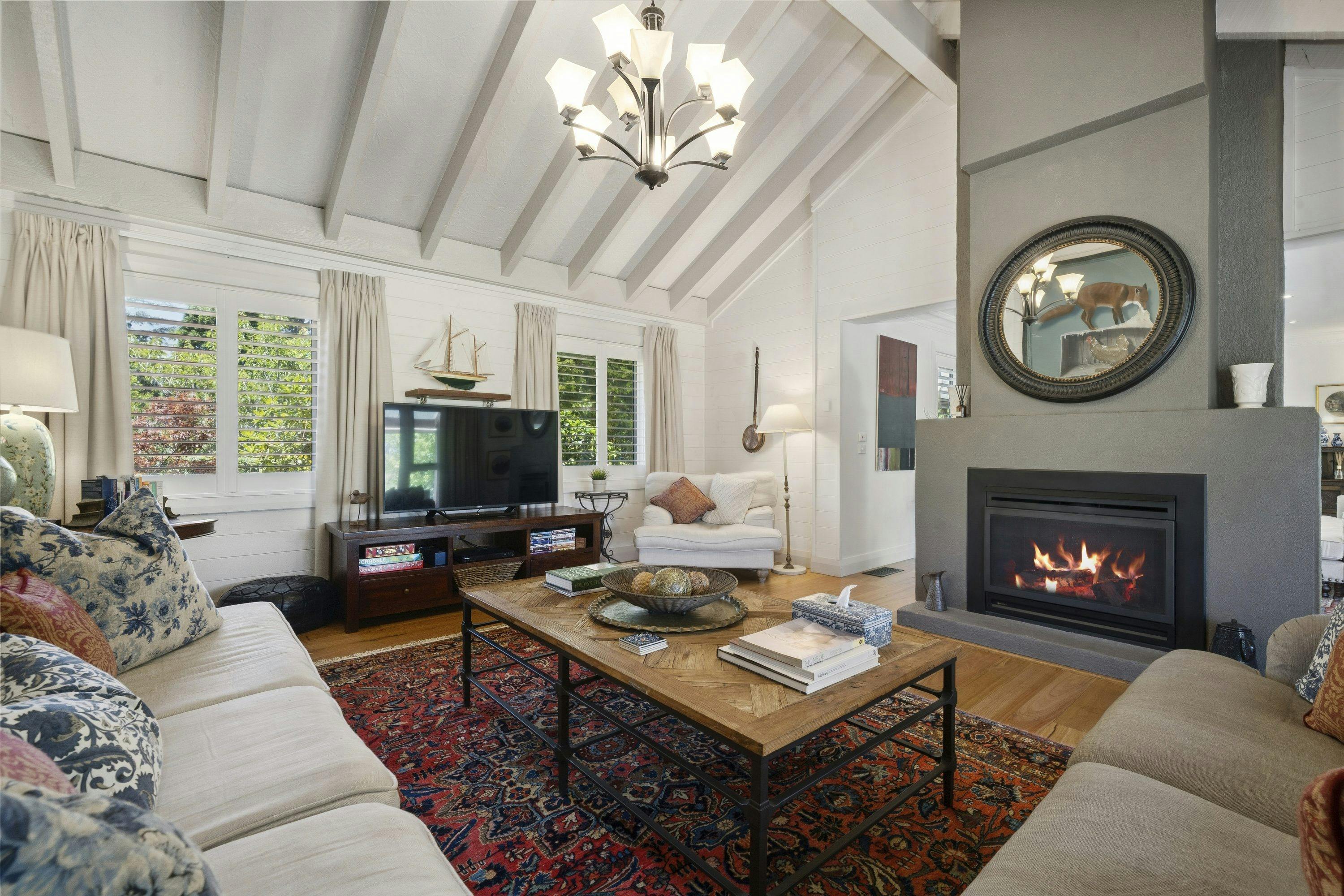 Living room with a vaulted ceiling, chandelier and gas fireplace