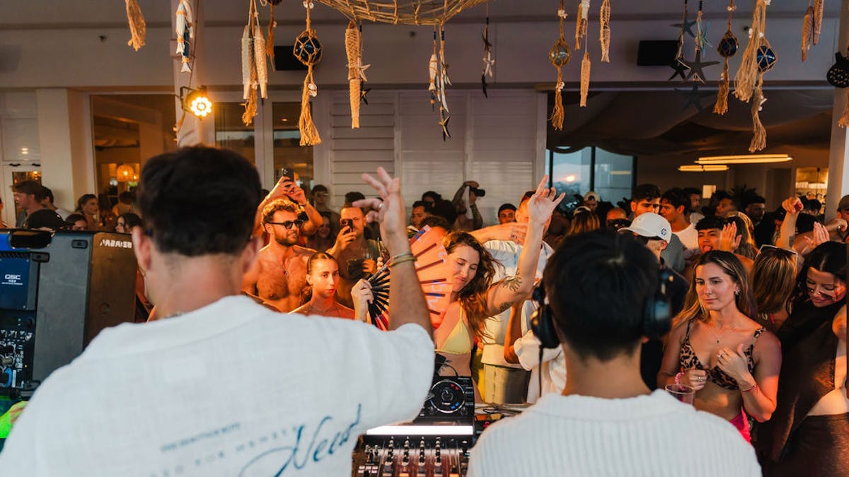 a group of people dancing and listening to live DJ's
